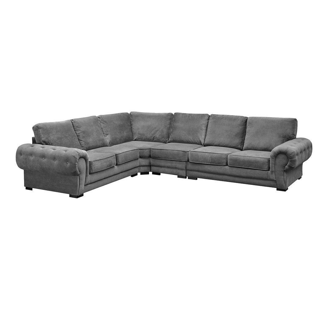 A dark grey full back corner sofa with six seats and chrome feet, displayed in a room setting.